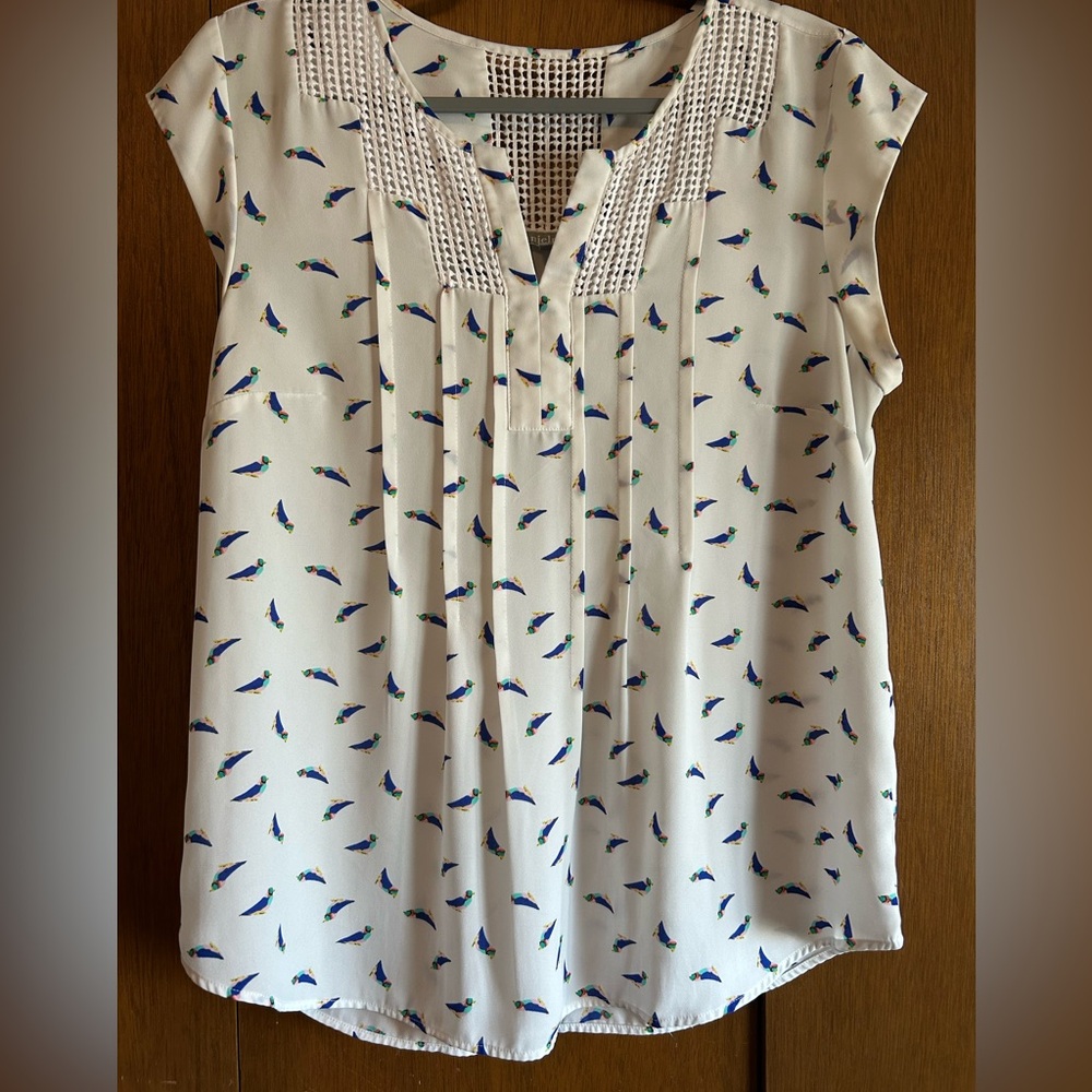 White sleeveless blouse with watercolor bird pattern